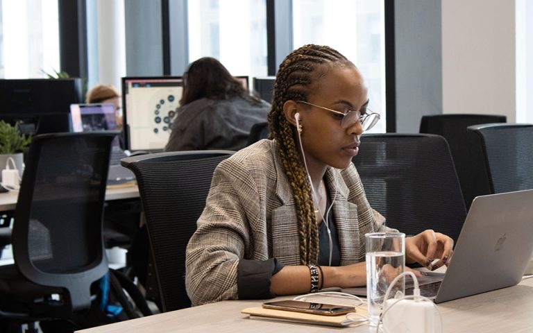 Girl working at desk with headphones on